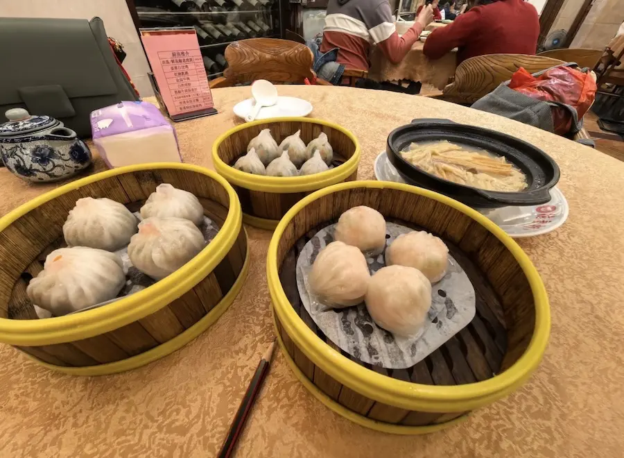 Cantonese morning tea yum cha with steamed dim sum baskets and tea on a restaurant table in Guangzhou