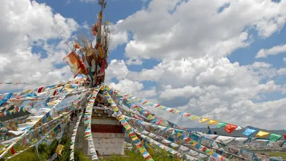 Hanging prayer flags at a mountain pass