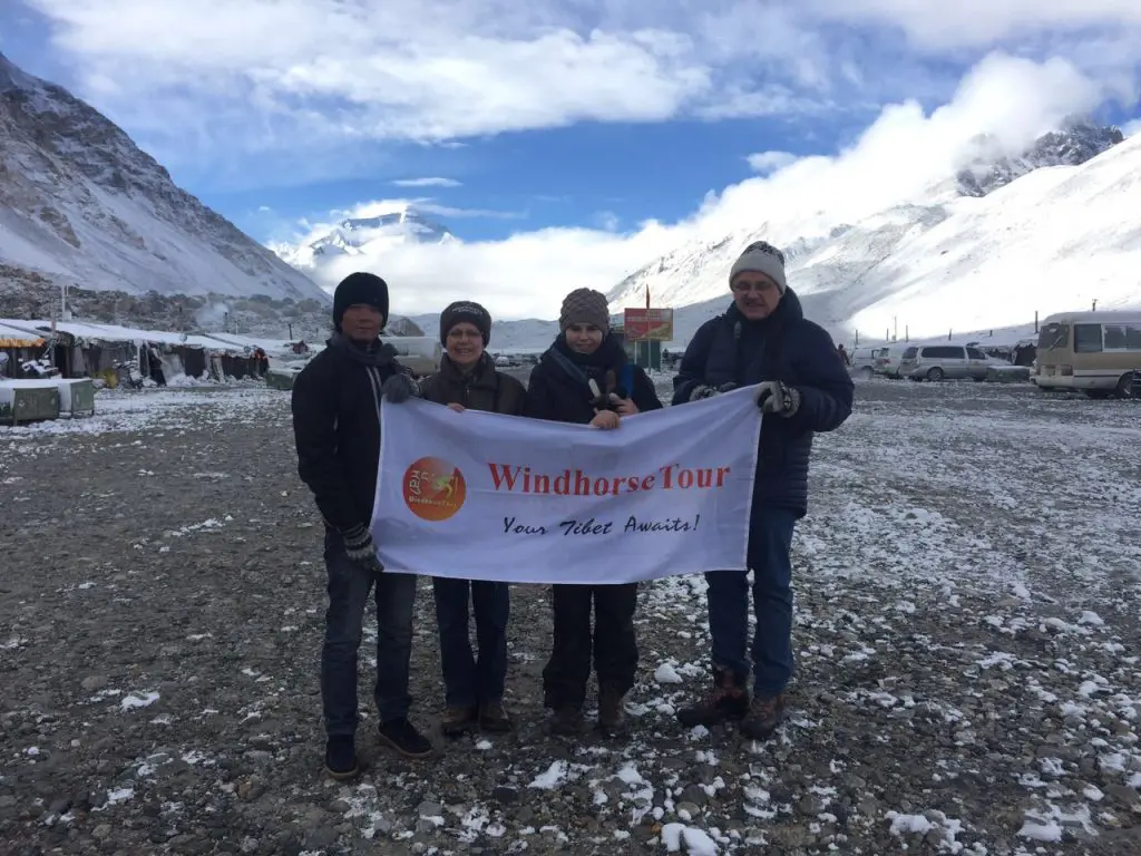 WindhorseTour Tibetan guide Gyantsen with travelers at Everest Base Camp in Tibet