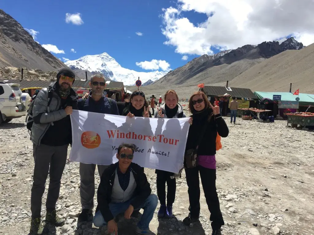 WindhorseTour travelers at Everest Base Camp with their Tibetan driver and guide Sonam 