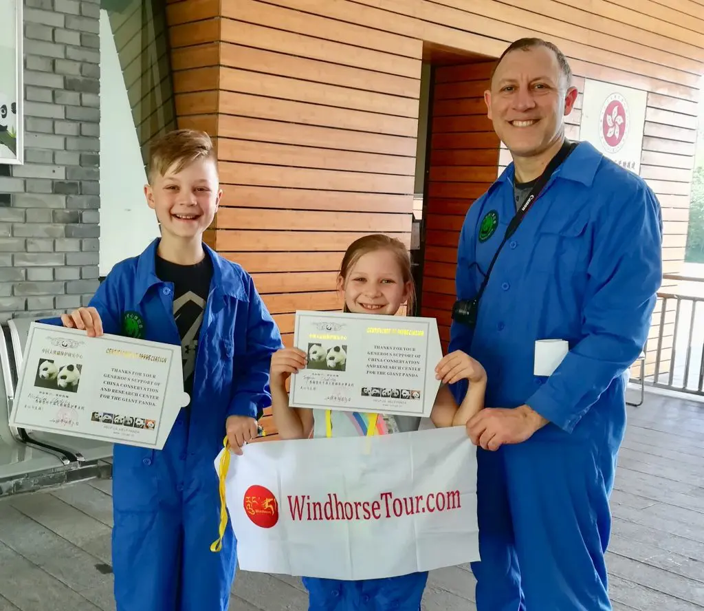 Kimberly Kids Took Photo with WindhorseTour Banner in Dujiangyan Panda Base