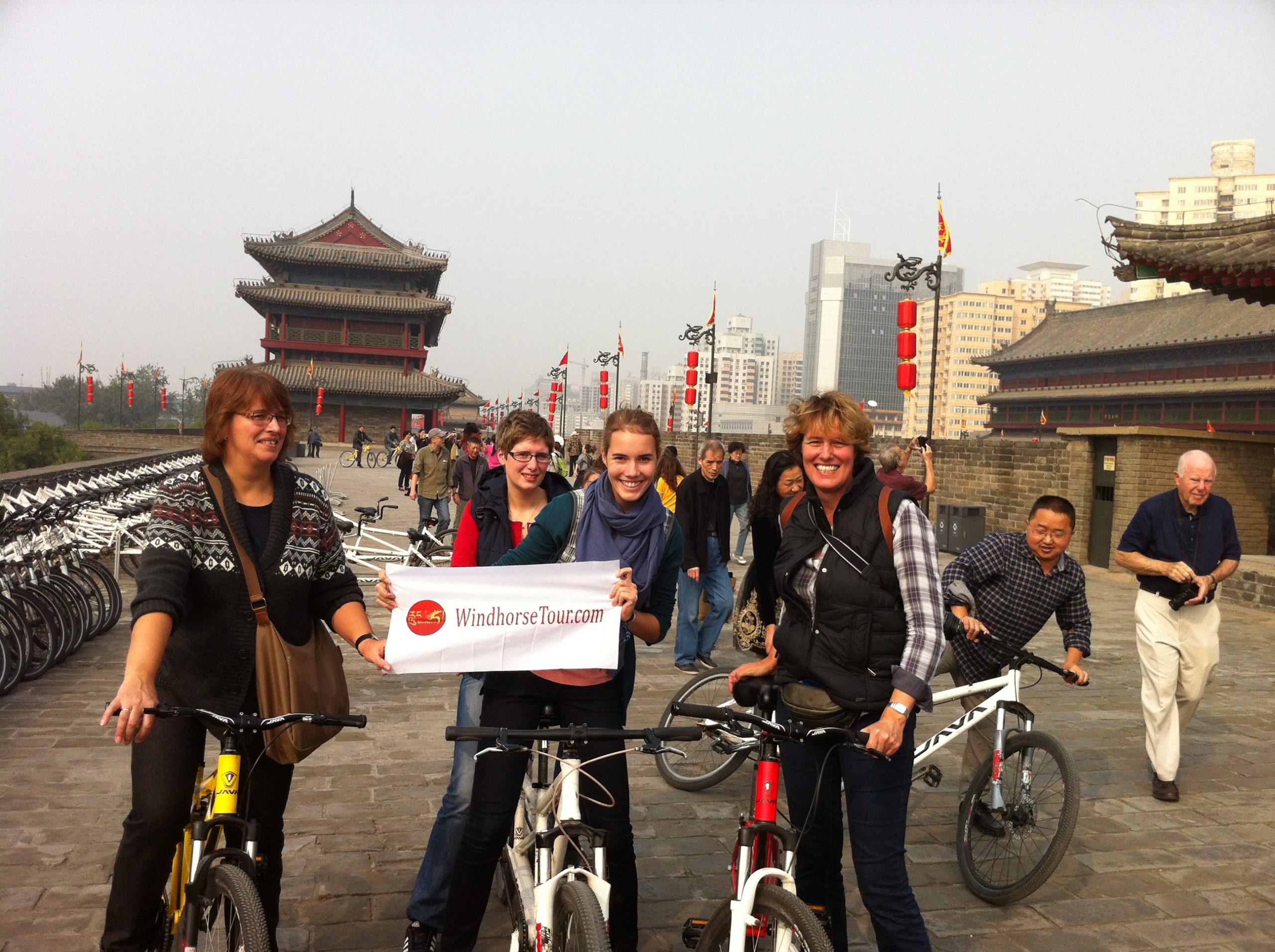 WindhorseTour travelers cycling on the ancient city wall in Xi’an